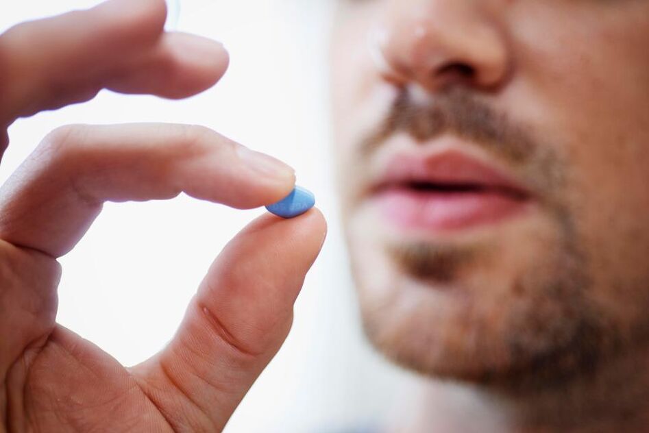 a man takes a pill to stimulate potency